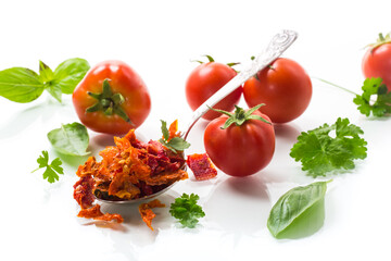 small pieces of dried tomatoes next to fresh tomatoes