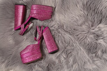 New pink high heeled shoes with platform and square toes on grey fur, flat lay. Space for text