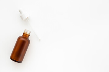 Essential serum oil in dropper bottle with pipette, top view