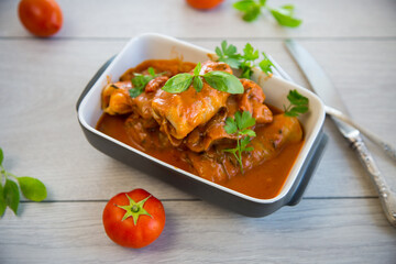 Traditional stuffed cabbage with minced meat and rice, served in a tomato sauce.