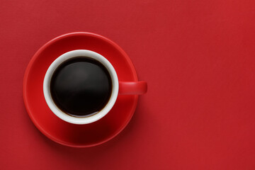 Cup with aromatic coffee on red background, top view. Space for text