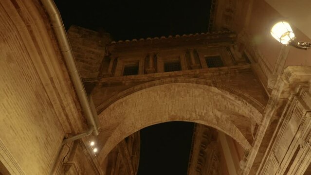 The Passage d Emili Aparicio Olmos that connects the Cathedral of Valencia and the Basilica at night, Spain