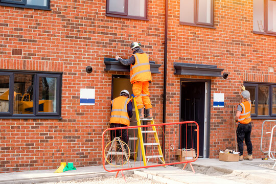 Construction site builder climbing on the ladder on working on hight