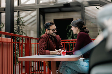 Businesswoman having a meeting with a male client, working together.