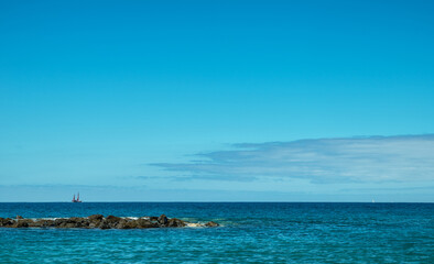 Fototapeta premium Calm ocean water and deep blue sky at the background.