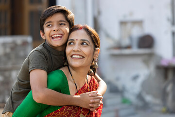 Fototapeta na wymiar Boy embracing his loving mother at home.