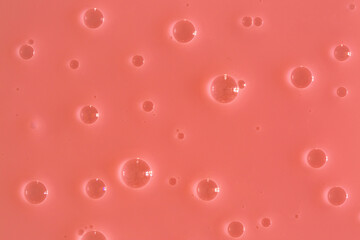 Bubble pink peachy background texture. Berry gel to cleanse the skin of the face and body. Spa treatments, skin care. Bath foam, detergent. Slime pink coral.