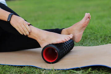 World health day. Unrecognizable woman warms up and works out the foot of the muscles of the body...