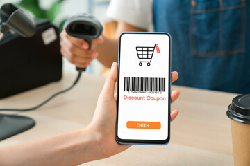 Hand using smartphone with scan barcode for discount code coupon, shopping online, Digital wallet concept.