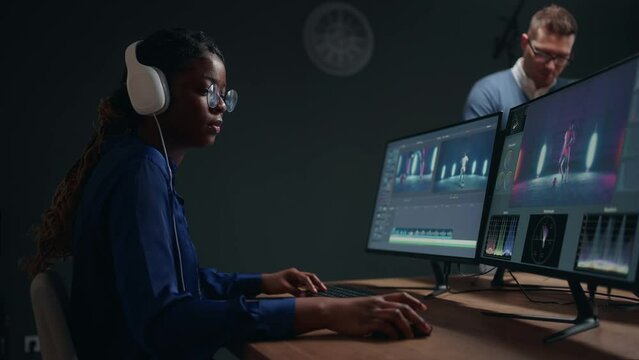 professional video editor and colorist woman creating new musical clip in studio, sound design