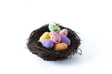 Colorful Easter eggs inside a nest isolated on white background