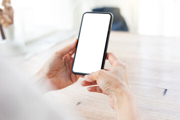 cell phone blank white screen mockup.hand holding texting using mobile on desk at office.background empty space for advertise.work people contact marketing business,technology