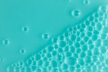 Bubble mint turquoise background texture. Berry gel to cleanse the skin of the face and body. Spa treatments, skin care. Bath foam, detergent. Slime blue