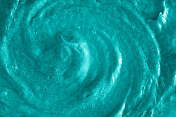 Smears of liquid turquoise gel texture background. Smeared oil paint with pearly shine. Cream scrub...