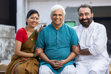 Fototapeta premium Happy Indian Couple Spending Time With Father At Home