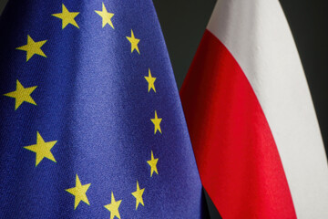 Close-up of small EU and Poland flags. - obrazy, fototapety, plakaty