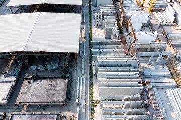 Aerial top view of Precast concrete wall panel for construction building site in warehouse factory. Precast concrete manufacturing products on prefabricated house factory