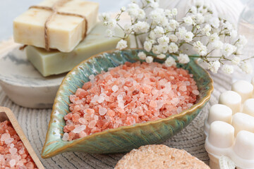 Sea salt, soap bars and dry shampoo on mat, closeup