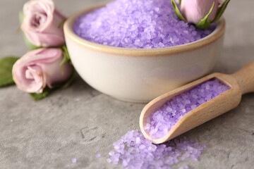 Obraz na płótnie Canvas Purple sea salt and beautiful flowers on light grey table, closeup