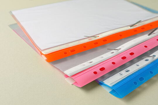 File folders with punched pockets on light grey background, closeup