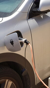 The process of charging an electric car. Rosette close-up