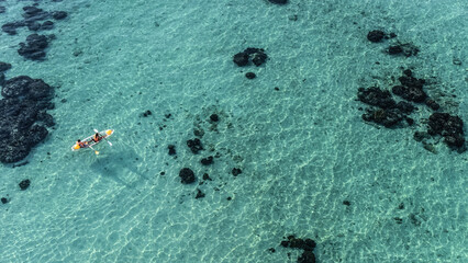 Aerial view of transparent kayak on the tropical blue sea. Seaside.