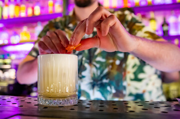 man hand bartender making white cocktail in glass on the bar counter