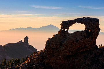 View at sunset of the island natural landmarks like Roque Nublo, the stone arch and Teide peak in the background, Grand Canary, canary Islands,, Spain