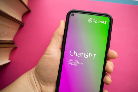 Nizhny Novgorod, Russia February 06 2023: text chatgpt and company name openai on smartphone screen in hand on magenta pink background