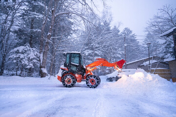 snow shovel tractor on a heavy snowy day  at Heike No Sato Village in Tochigi Prefecture, Nikko City, JAPAN
