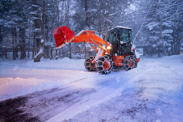 snow shovel tractor on a heavy snowy day  at Heike No Sato Village in Tochigi Prefecture, Nikko City, JAPAN