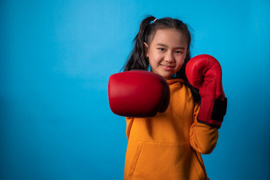 the studio isolated a portrait image of the girl wearing the boxing gloves