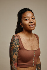 Young black woman looking at camera with tattoos and real skin texture