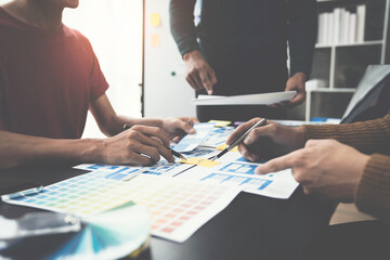 ux developers, UI designers Asian group data researchers brainstorm on tabletop mobile app...