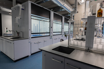 Chemical laboratory. White cabinets. Vials with chemicals. Chemists workplace. The interior of the...
