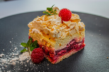 Dessert served on a sumptuous plate. Appetizing looking food. A gourmet restaurant. Romantic dinner. Colorful cookie. Pavlova cake.