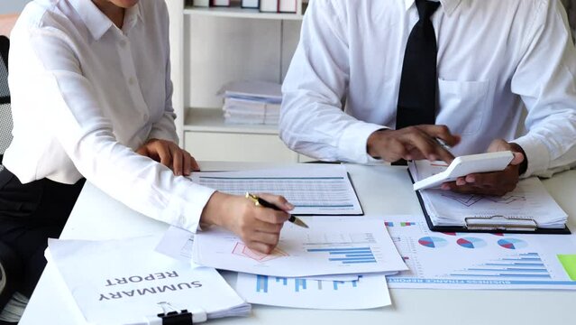 Accounting team manager working with cash flow chart and balance sheet, asset paperwork with stock market monthly statics