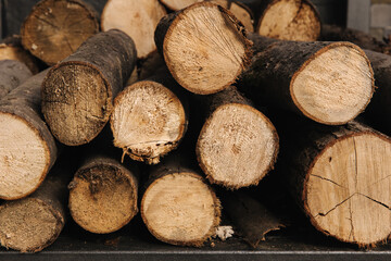 Closeup of chopped firewood. Firewood stacked and prepared. Natural wooden backgroun