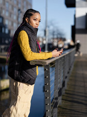 Young woman using phone in urban setting
