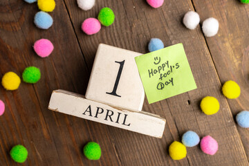 April 1st. Image of april 1 wooden calendar with colorful decor on wooden background. April Fool's...
