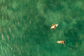 Indonesia, Lombok, Aerial view of men surfing in sea