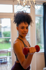 Fototapeta na wymiar Young woman exercising at home