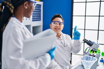 African american mother and son scientists smiling confident doing idea gesture laboratory