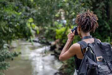 Indonesia, Bali, Female tourist photographing river during hike