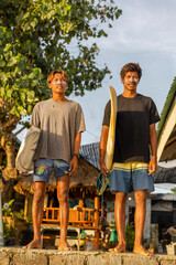 Fototapeta Surfers standing with surfboards on sunny day obraz
