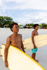 Fototapeta Indonesia, Lombok, Surfers looking at view from beach obraz