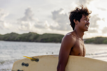 Fototapeta Indonesia, Lombok, Side view of male surfer looking at view obraz