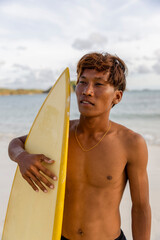 Fototapeta Indonesia, Lombok, Portrait of serious male surfer against sea� obraz