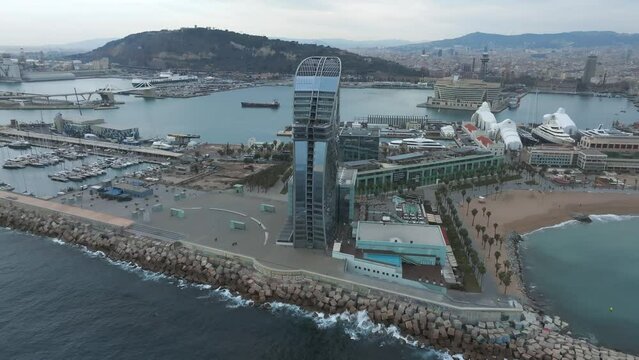 View of the Barceloneta beach with luxury hotel W Barcelona by the sea shore. Beautiful luxury hotel in Barcelona.