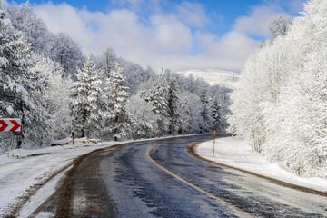 Mountain road landscape covered in snow in winter - 568791569